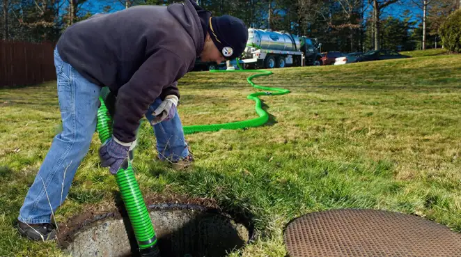 Service technician performing residential septic pumping and drainage maintenance in New Haven, CT
